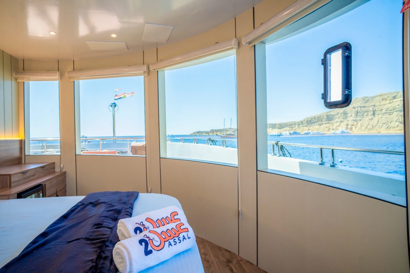 Suite with a double bed and panoramic sea windows