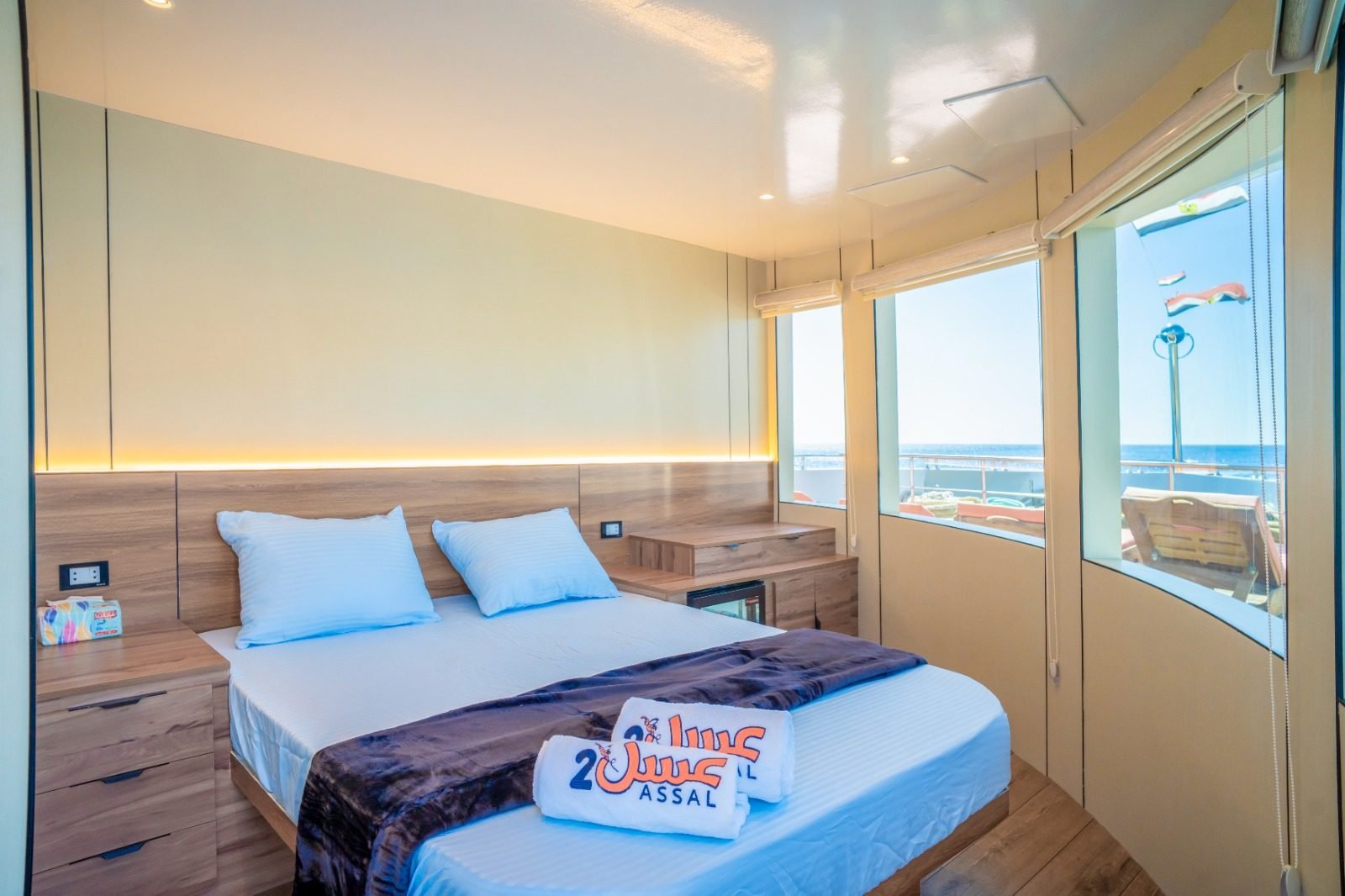 Suite with a double bed and panoramic sea windows